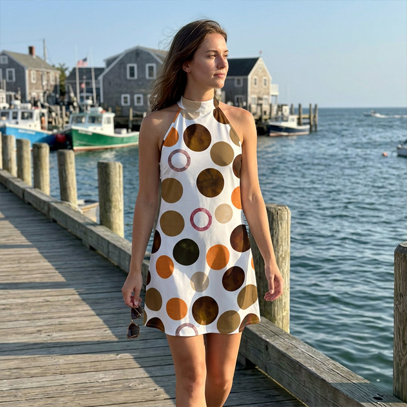 Brown polka dot halter A-line dress by the waterfront